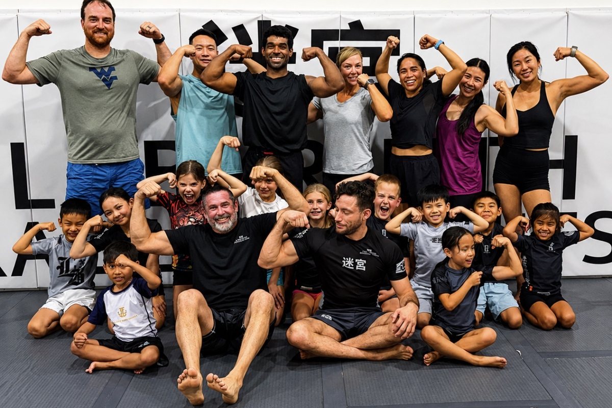 The all-ages strength and conditioning class at Labyrinth BJJ in Fulshear, TX — adults standing at the back and kids kneeling at the front, all flexing